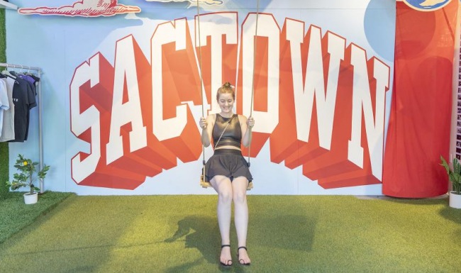 a person posing in front of a sign