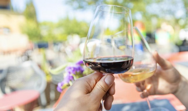 a couple of people holding wine glasses